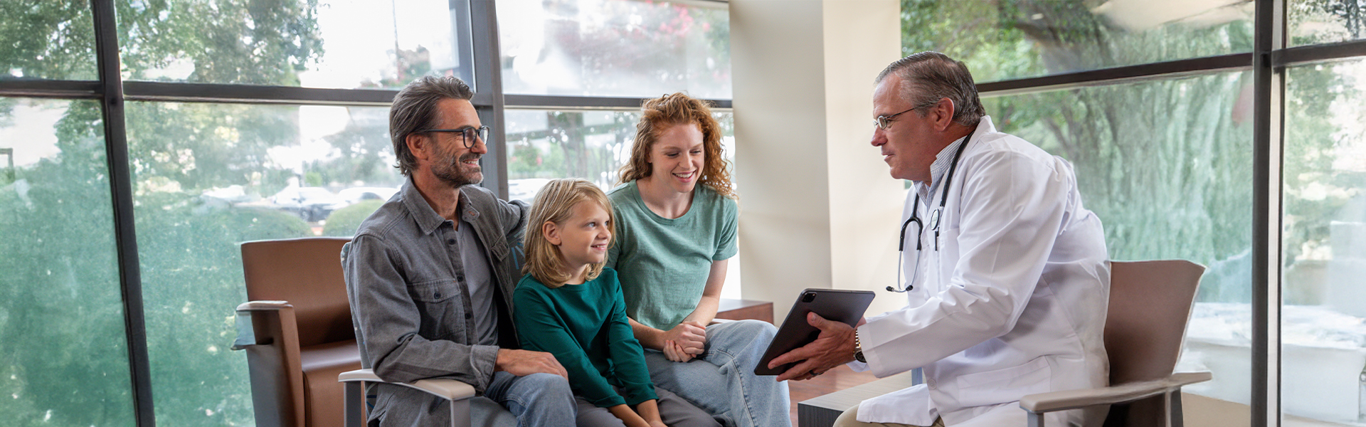 family with physician in waiting room