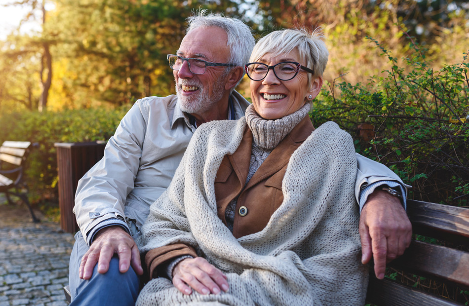 Two adults sitting on a bench outdoors
