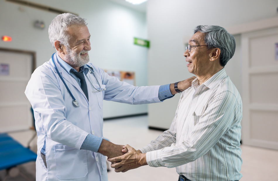 Doctor shaking hands with a patient during a clinic visit