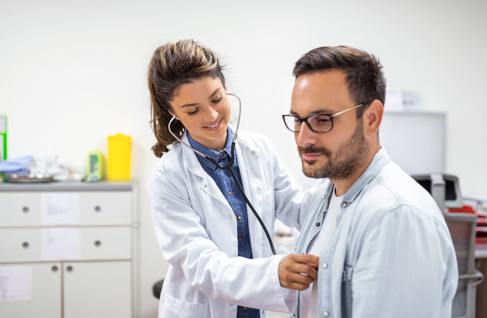 Doctor using a stethoscope to examine a patient during checkup