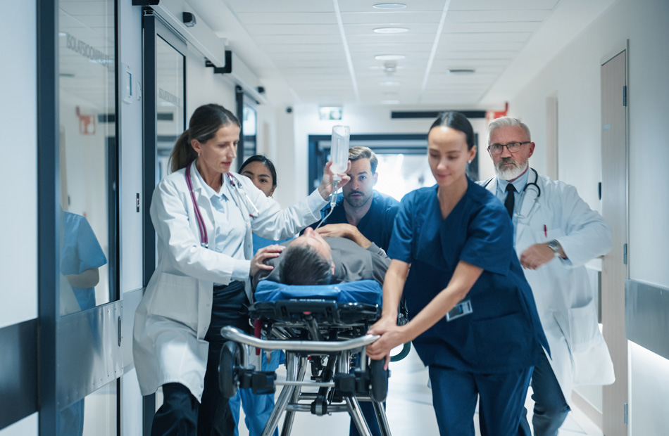 Emergency care team moving a patient through a hospital corridor