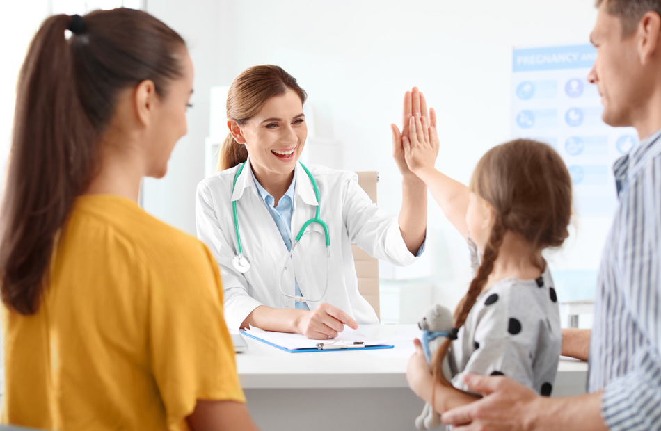 Clinician giving high five during pediatric visit