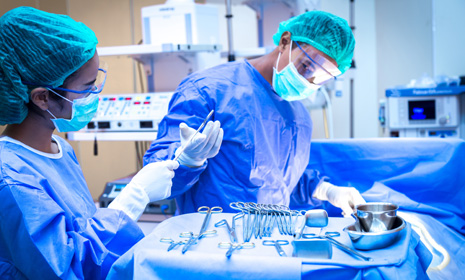 Surgical team preparing instruments in operating room