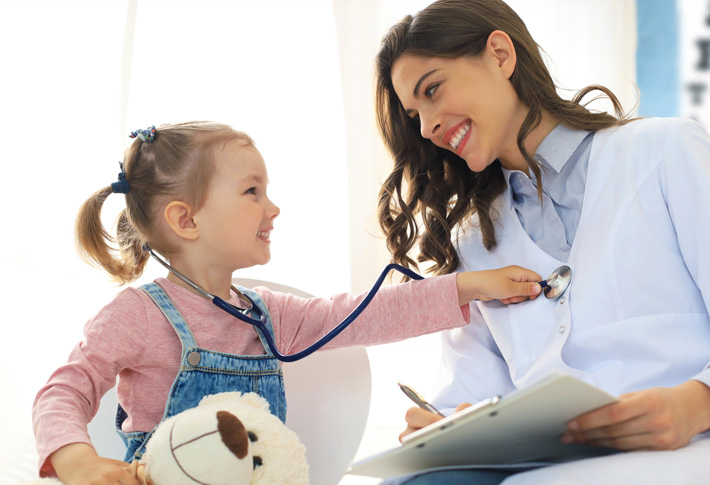 Child examining a doctor with a stethoscope