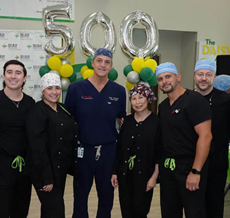 Dr. Joseph Ricotta and surgical team celebrate surpassing 500 TCAR procedures with commemorative balloons and staff recognition.