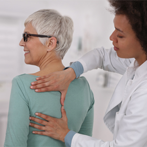 Doctor performing a back assessment