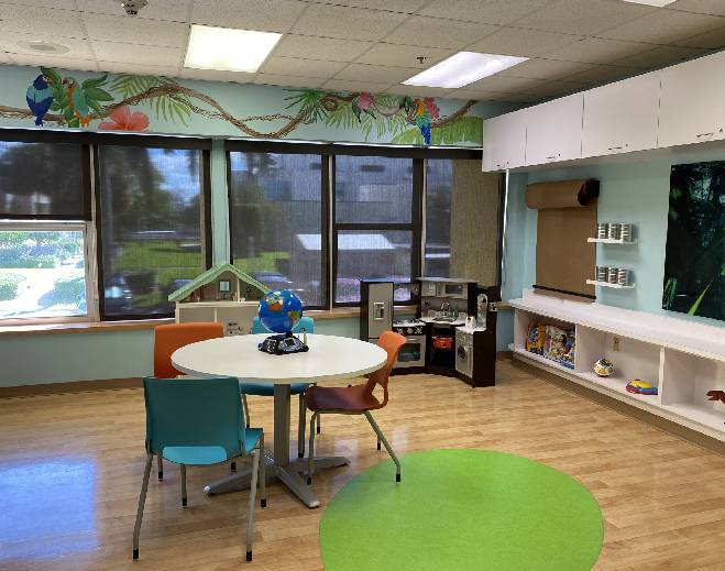 Play room with toys and activity tables