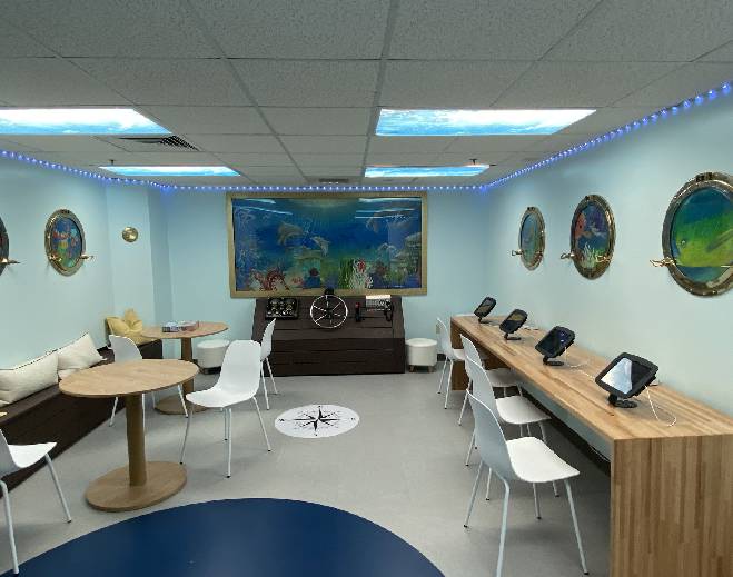 Play room with tables, chairs, and activity stations