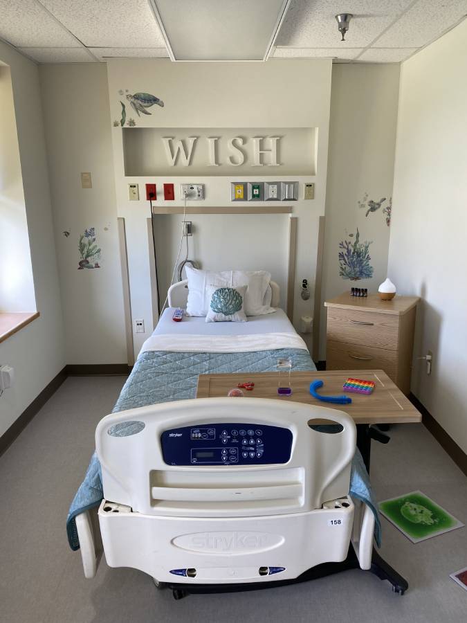 Hospital room with sensory-friendly decor and a patient bed