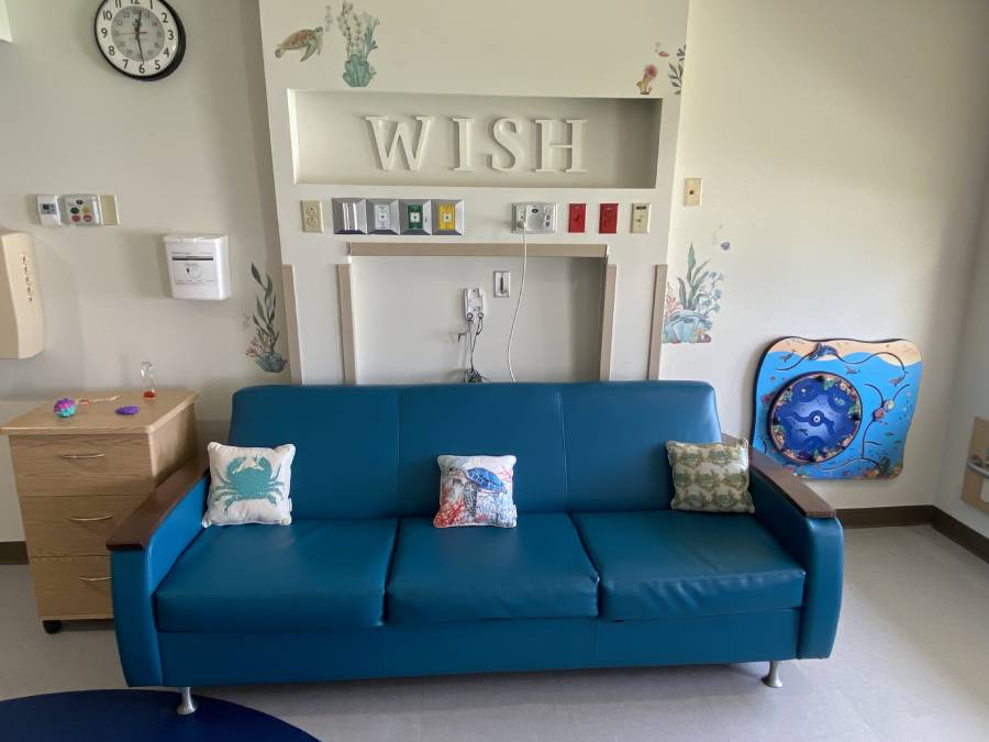 Sensory room with a couch and sensory wall features